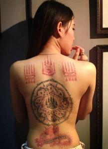 girl with talisman tattoos